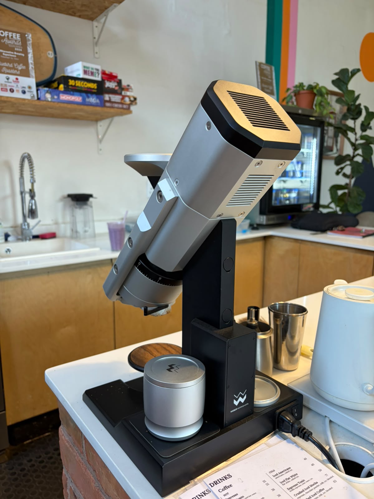 The Weber HG-1 grinder with Coffee Magazine Awards certificate on the shelf behind