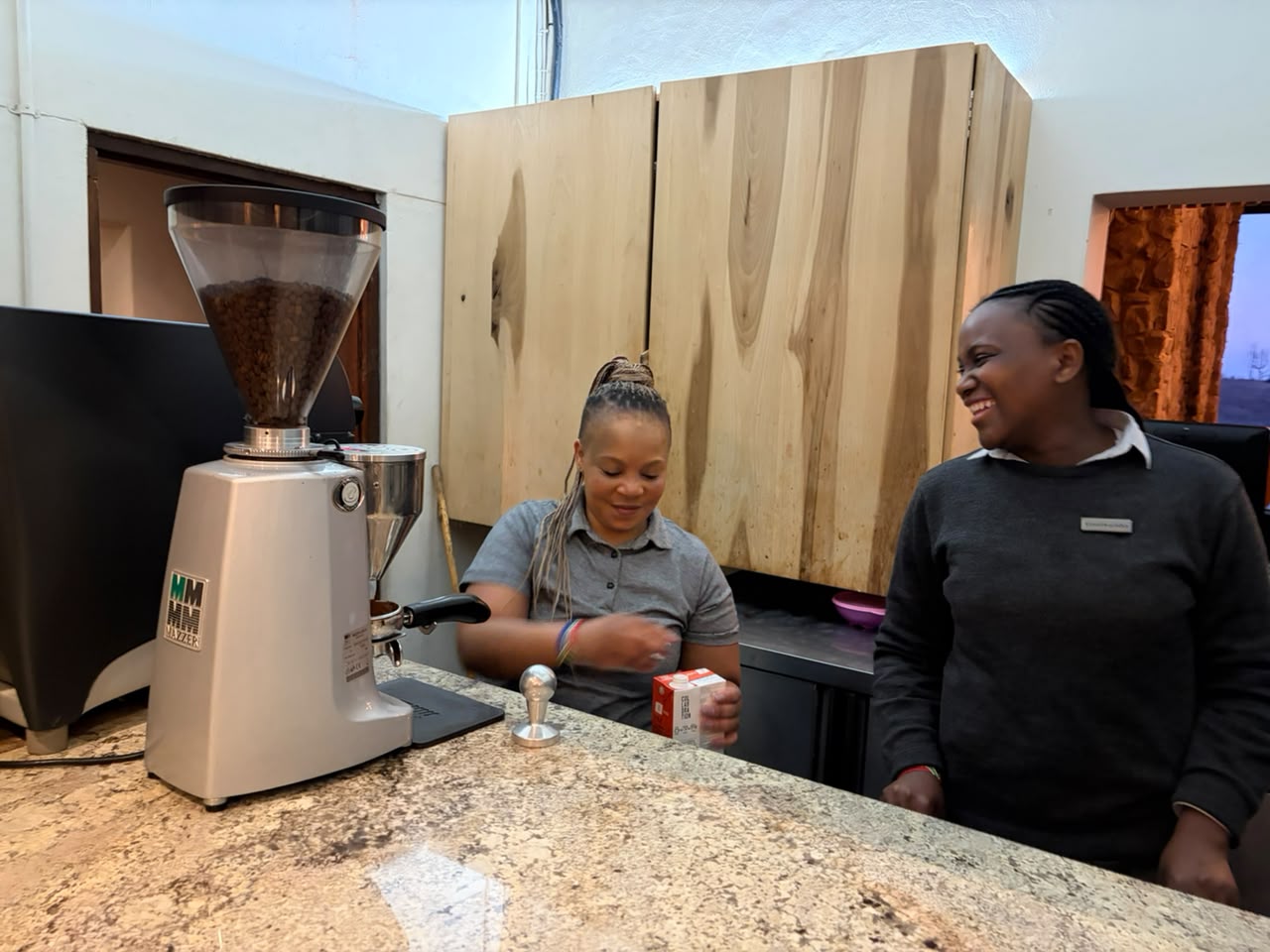The baristas behind the counter at Brahman Hills with their Mazzer grinder and Rancilio setup