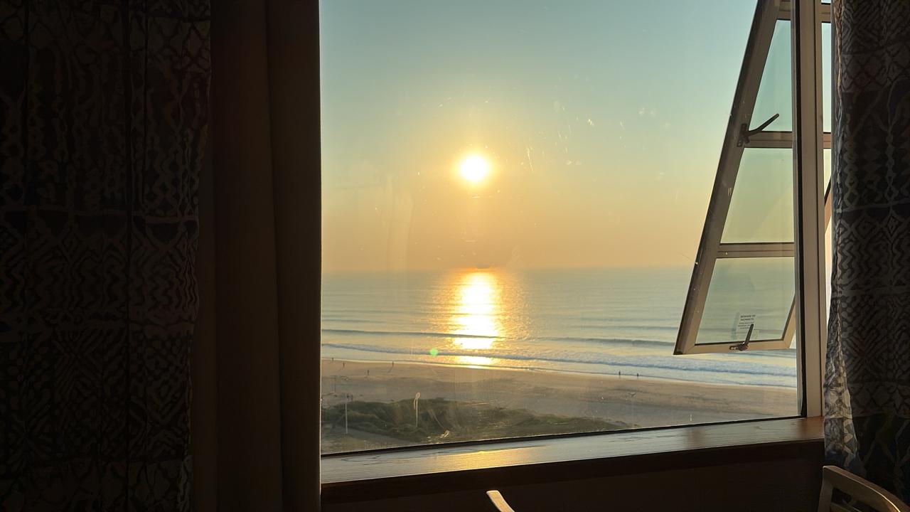 Sunrise over the Indian Ocean seen through an open hotel window in Durban
