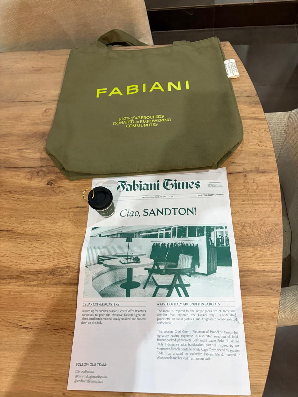 The Fabiani Times newspaper and an olive-green Fabiani tote bag with 