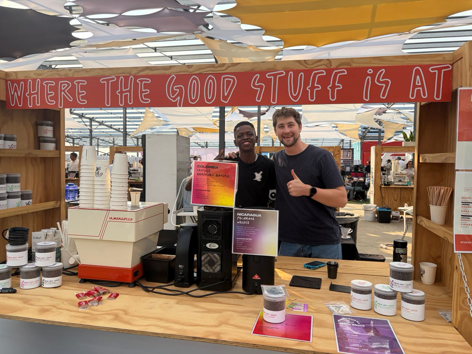 Robin Chat / Four Gray Coffee stand at Jo'burg Coffee Festival 2026 — WHERE THE GOOD STUFF IS AT, La Marzocco, Colombia and Nicaragua cards