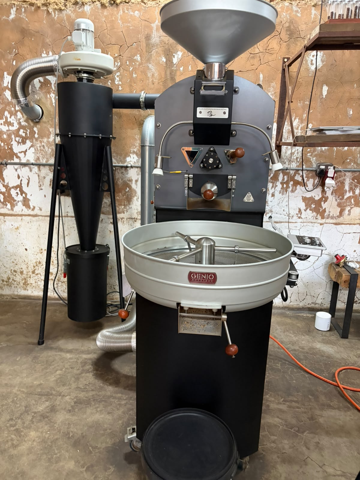 Close-up of the Genio roaster showing the cooling tray with mixing arms and the control panel