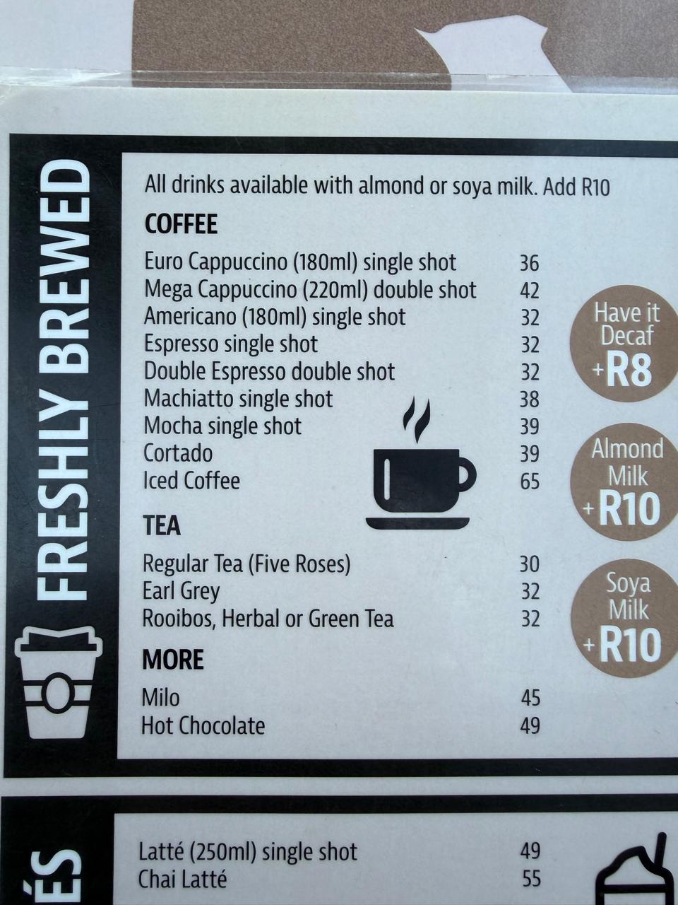 Surf Riders coffee menu — Freshly Brewed section showing espresso, cappuccino, americano, cortado, iced coffee with prices in Rands