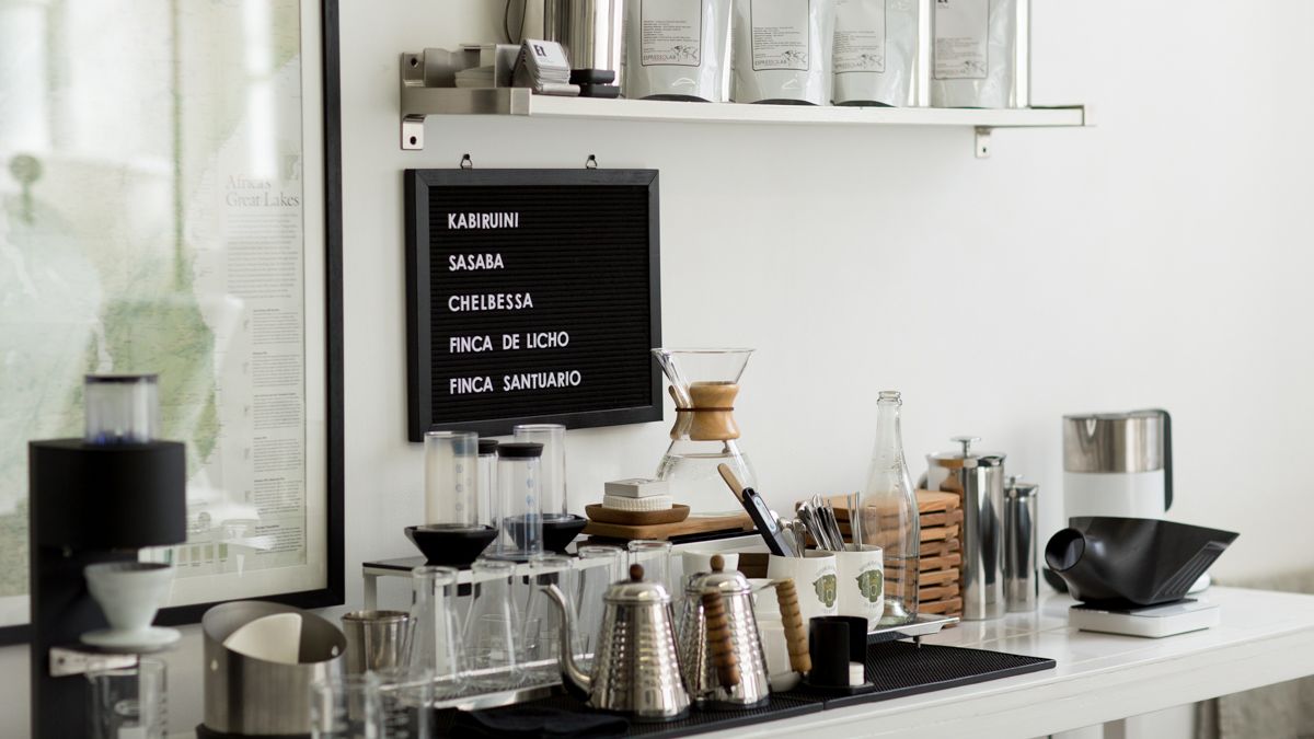 Espresso Lab Microroasters interior — clinical white tiles, laboratory aesthetic